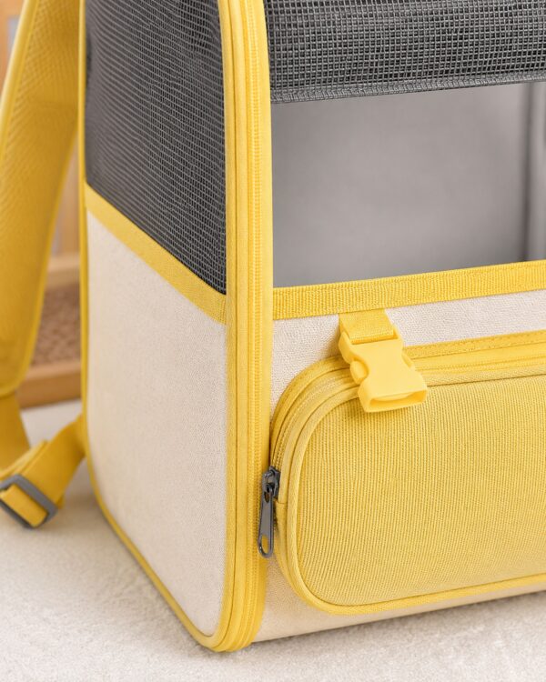 Close-up of the yellow zip and shoulder strap on the grey pet backpack.