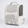 White and grey pet backpack carrier with a mesh side panel and small flower detail on a plain background.