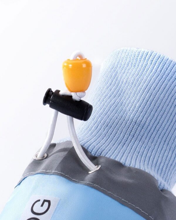 Close-up of the cord toggle that cinches the top of the light blue dog boot.