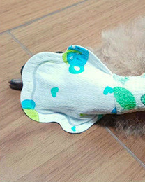 An original supplier side view shows a soft printed cover around a dog paw and ankle.