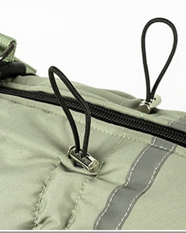 Close view of the sage suit’s waist drawcords, metal stops, and back zipper.