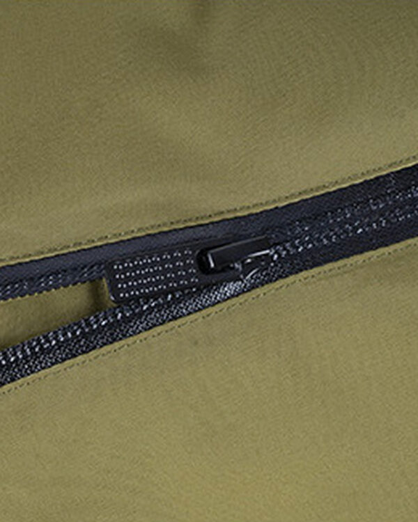 The green suit’s black back zipper and elongated pull shown in an original detail crop.